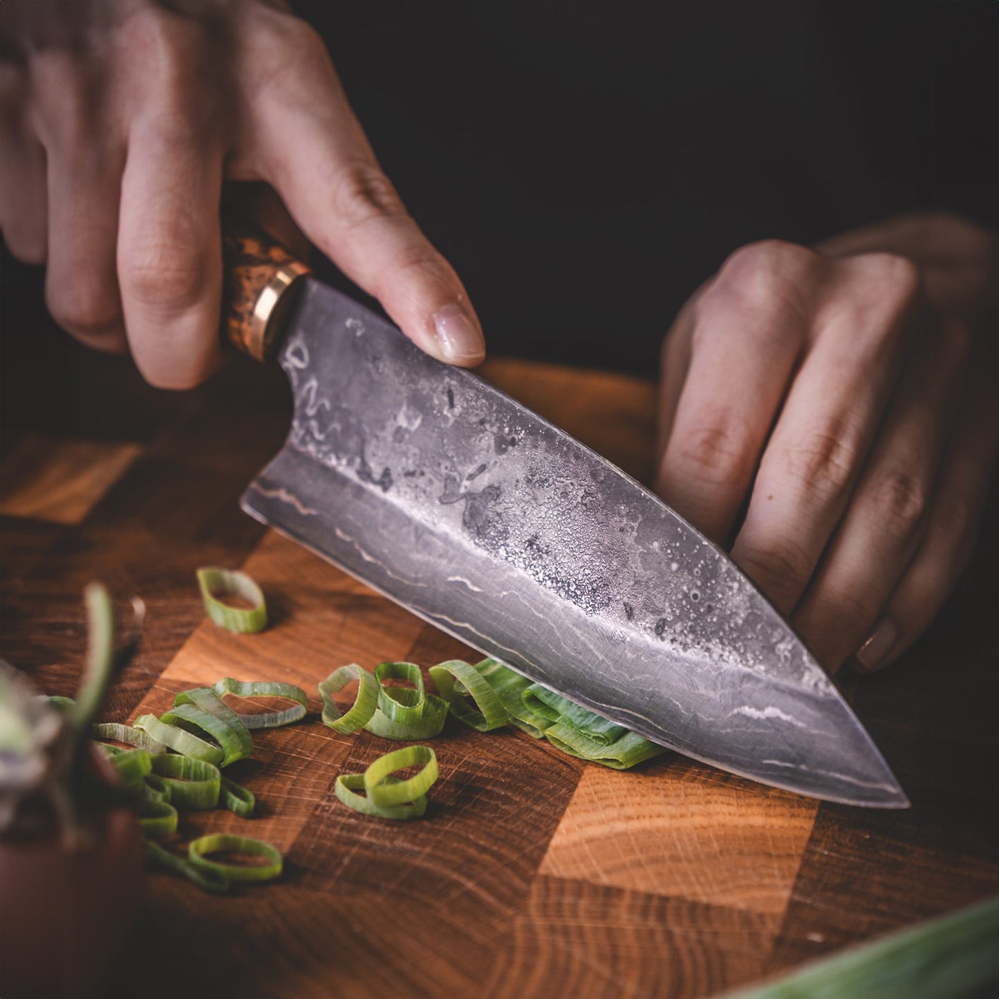 Handmade Damascus steel kitchen knife made by hand in our factory in Finland. The Damascus steel has 37 layers of steel. Comes with a handle made from stained curly birch and a handmade leather sheath.